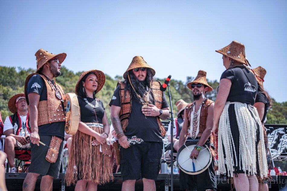 group of Puyallup Tribe members gathering in an open circle to sing