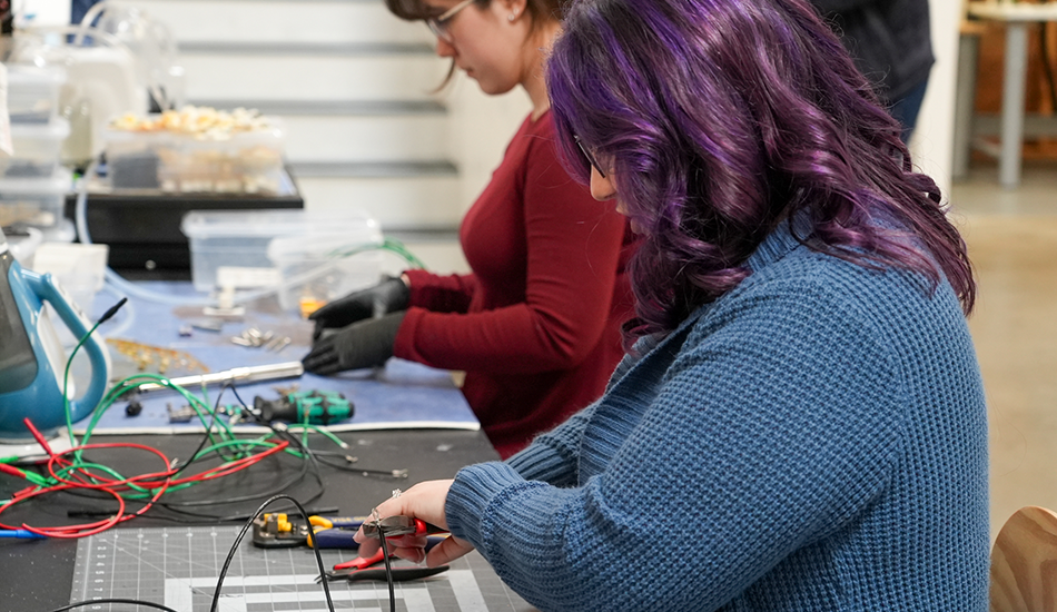Skip Tech employees building battery cells